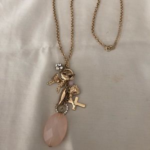 A long gold charm necklace